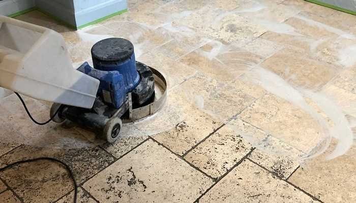 Worn travertine floor being ground and honed